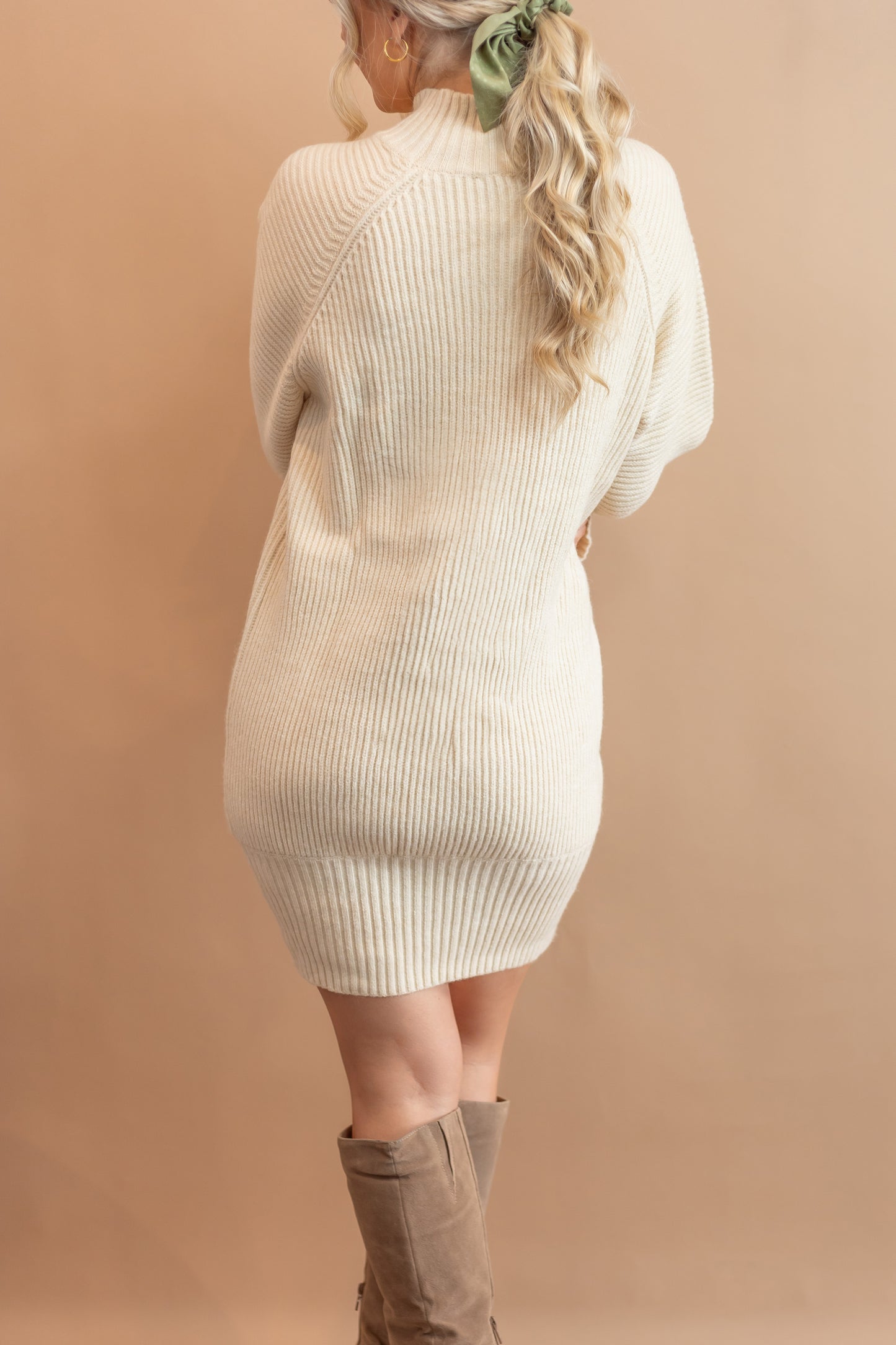 woman's cream sweater dress back view