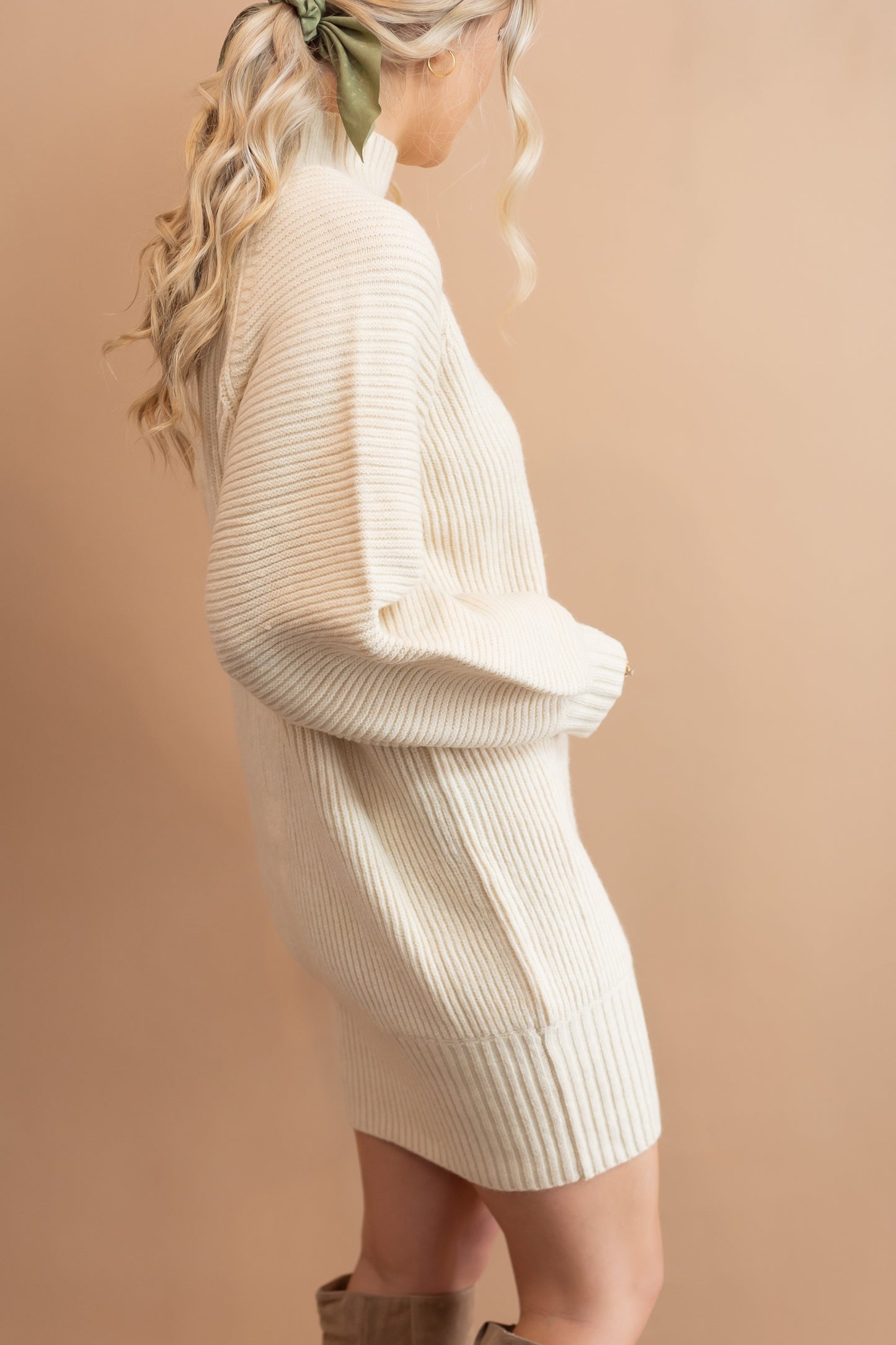 woman's cream sweater dress side view
