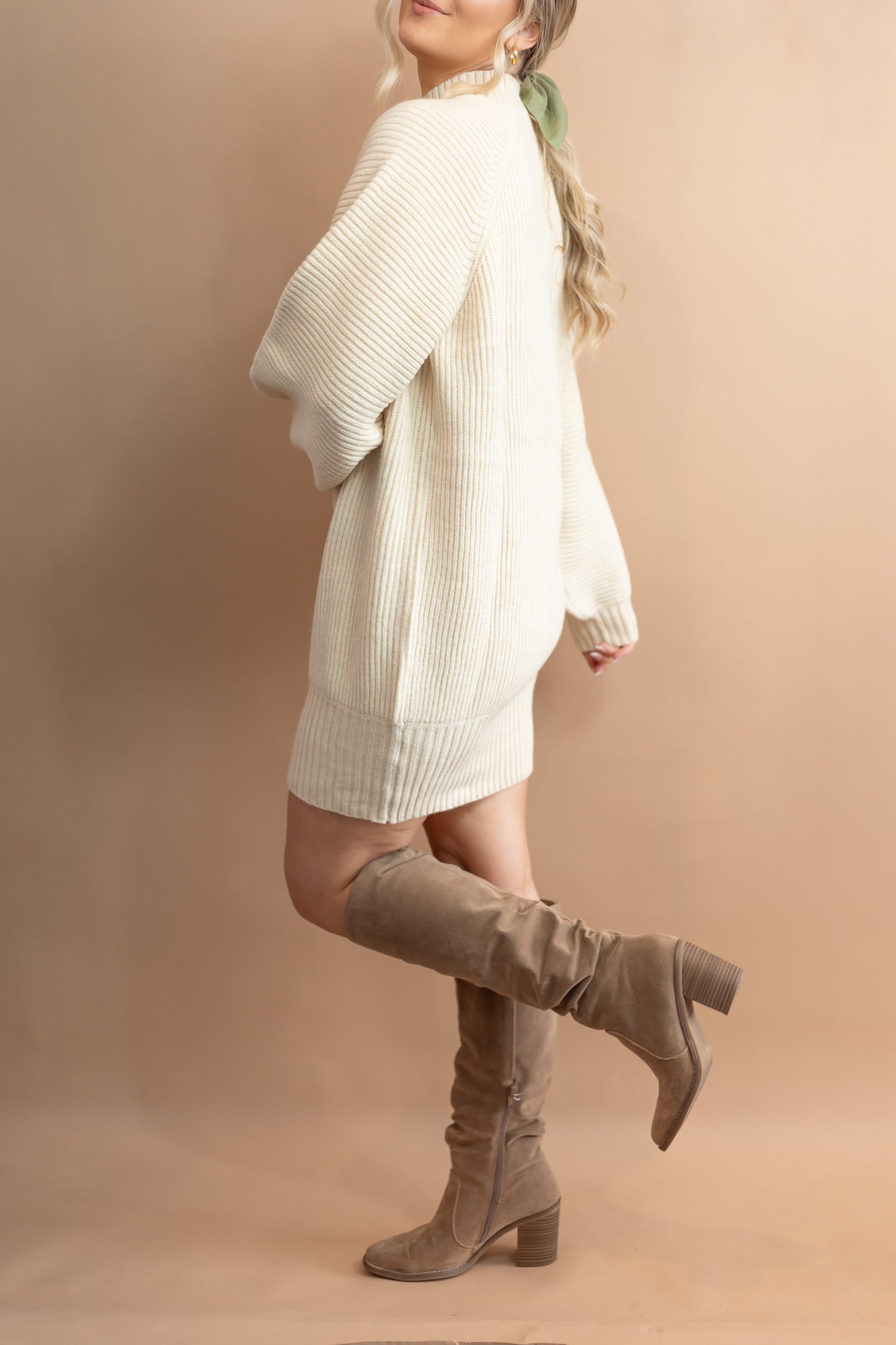 woman's cream sweater dress side view