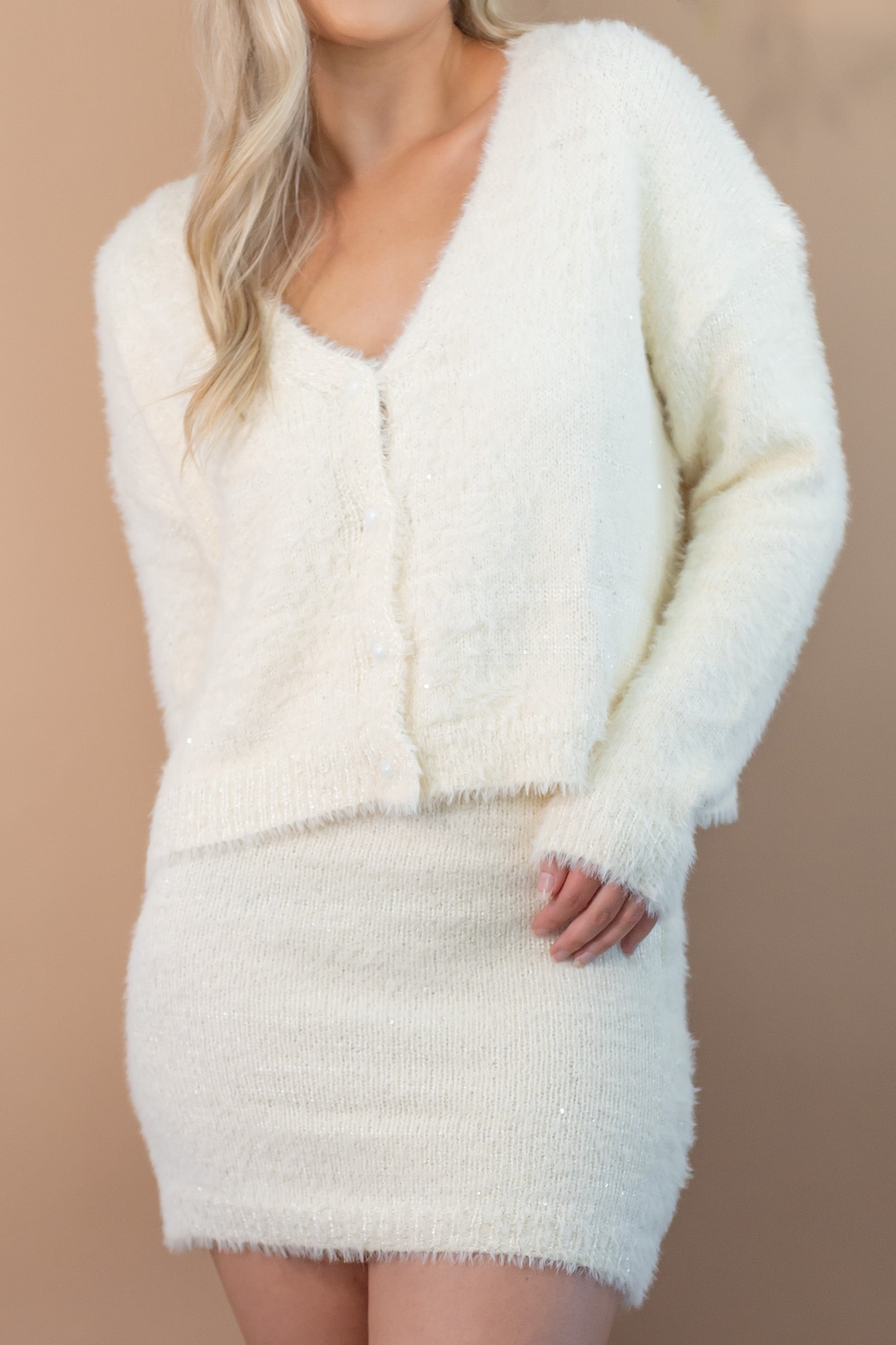 woman's white fuzzy button up cardigan v-neck bodycon short skirt with tiny sequins front view