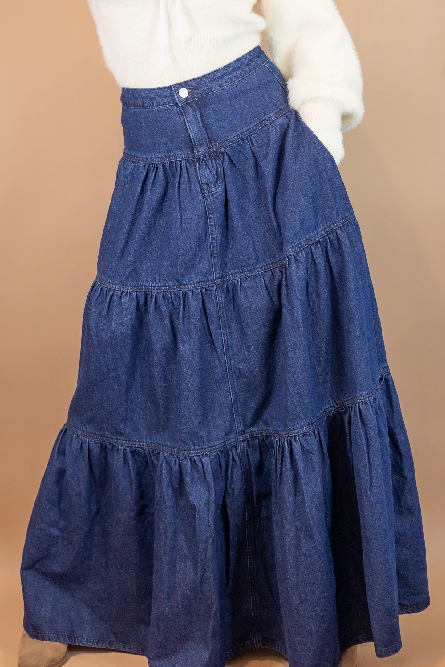 woman's blue denim maxi length skirt hand in pocket