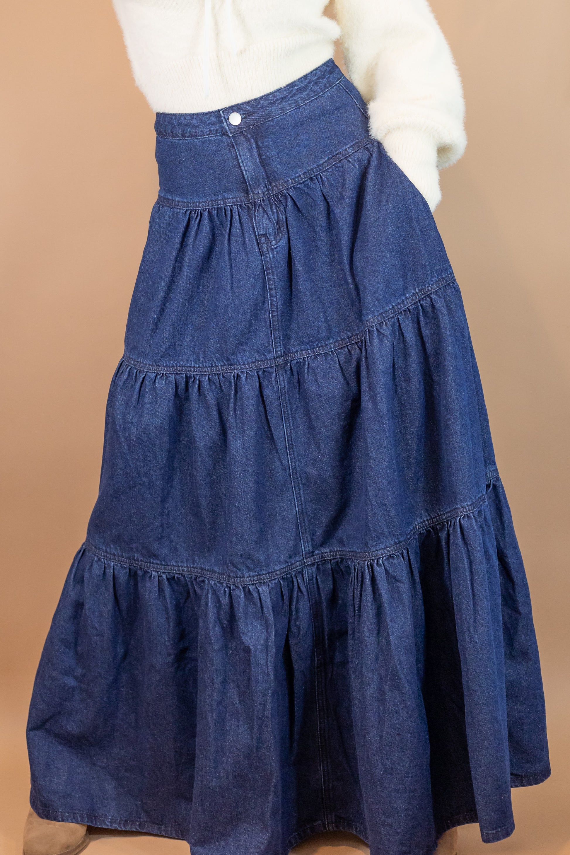 woman's blue denim maxi length skirt hand in pocket