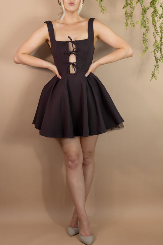 Woman's short fit and flare brown dress with cutout panel and three bow ties
