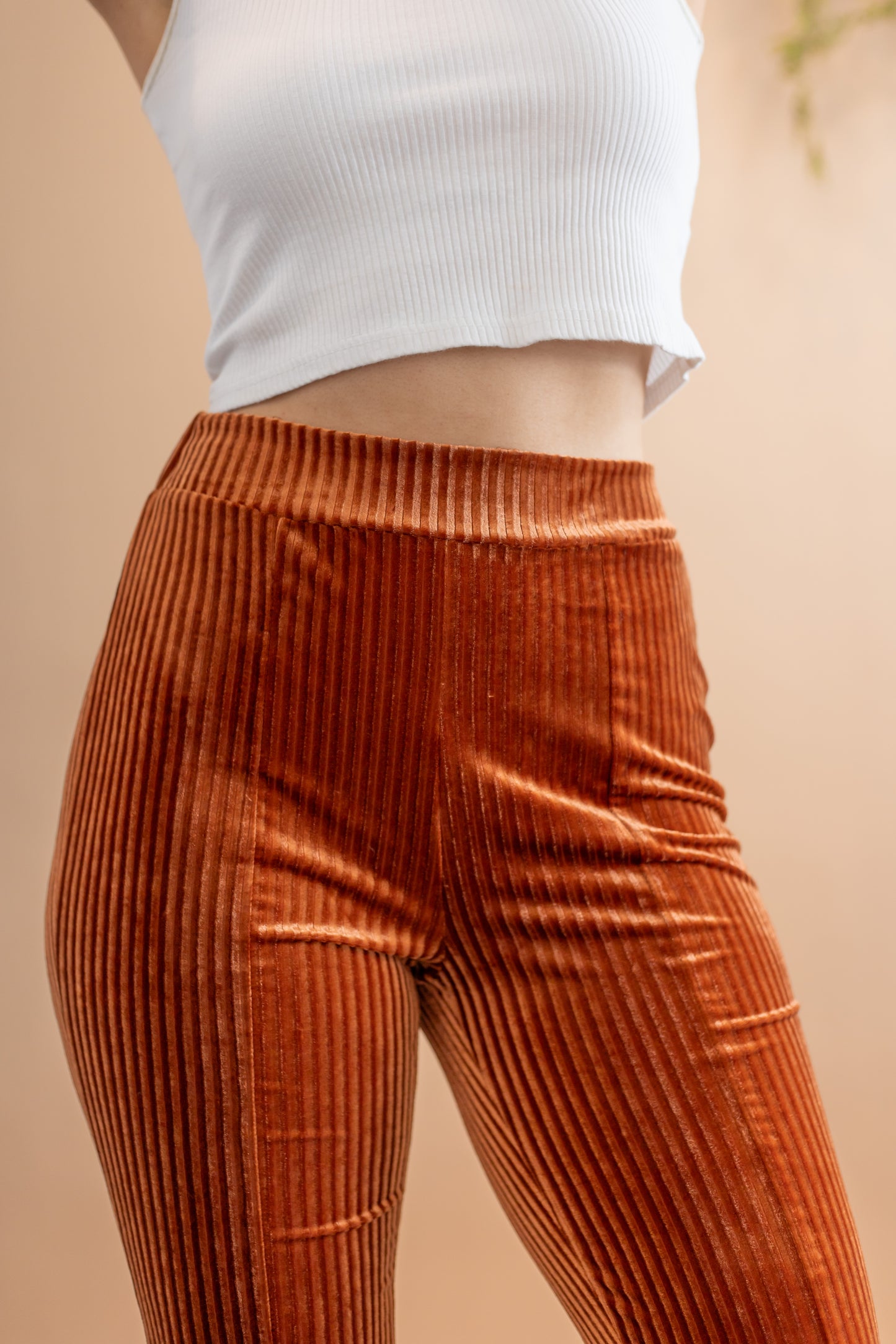 Woman's copper stretchy corduroy  high waisted flare pants close up front view