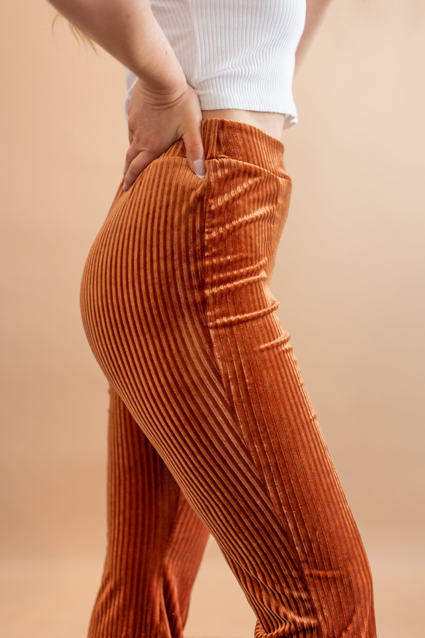 Woman's copper stretchy corduroy  high waisted flare pants side view