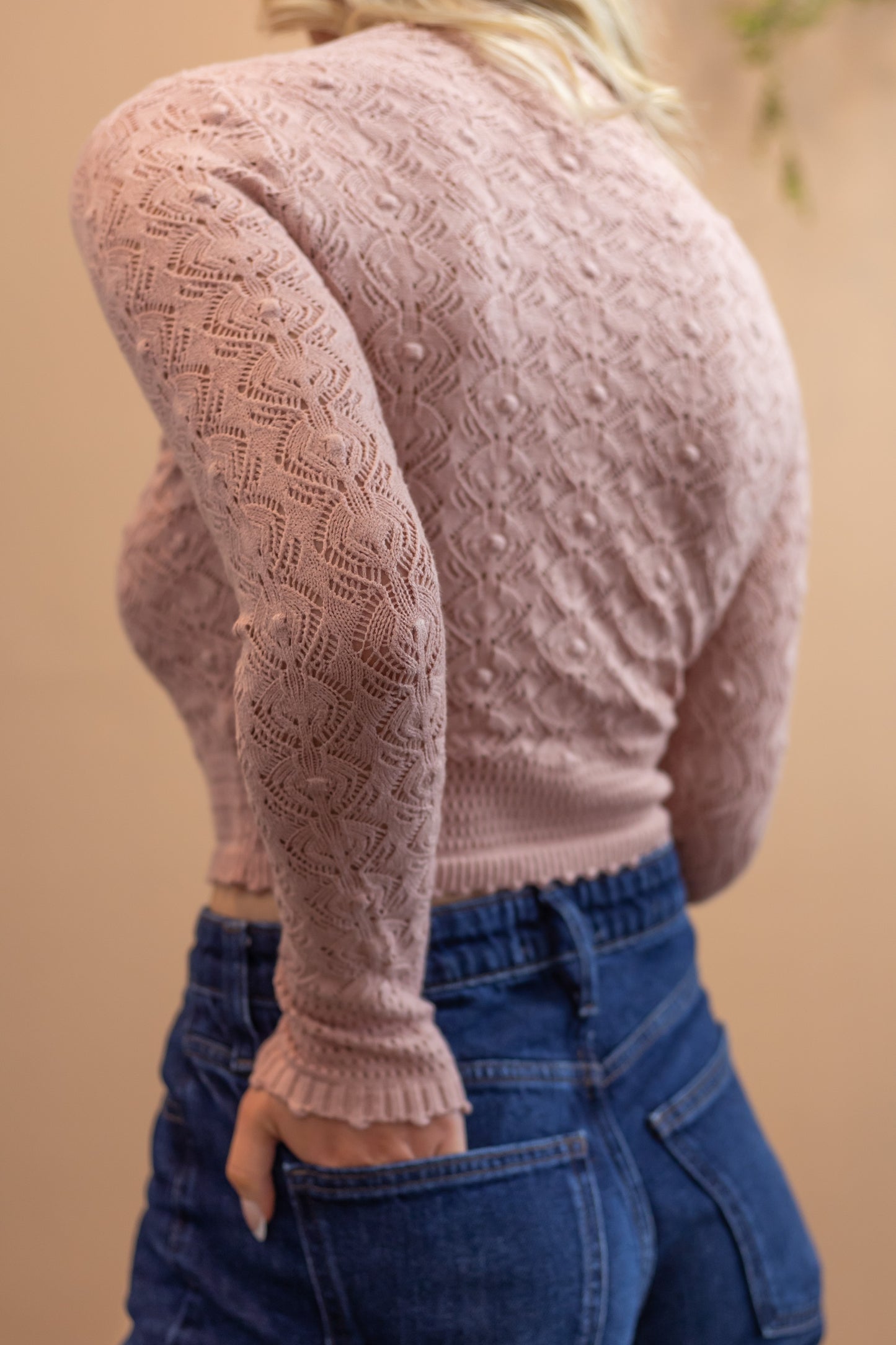 Pink textured long sleeve mock neck woman's top back view
